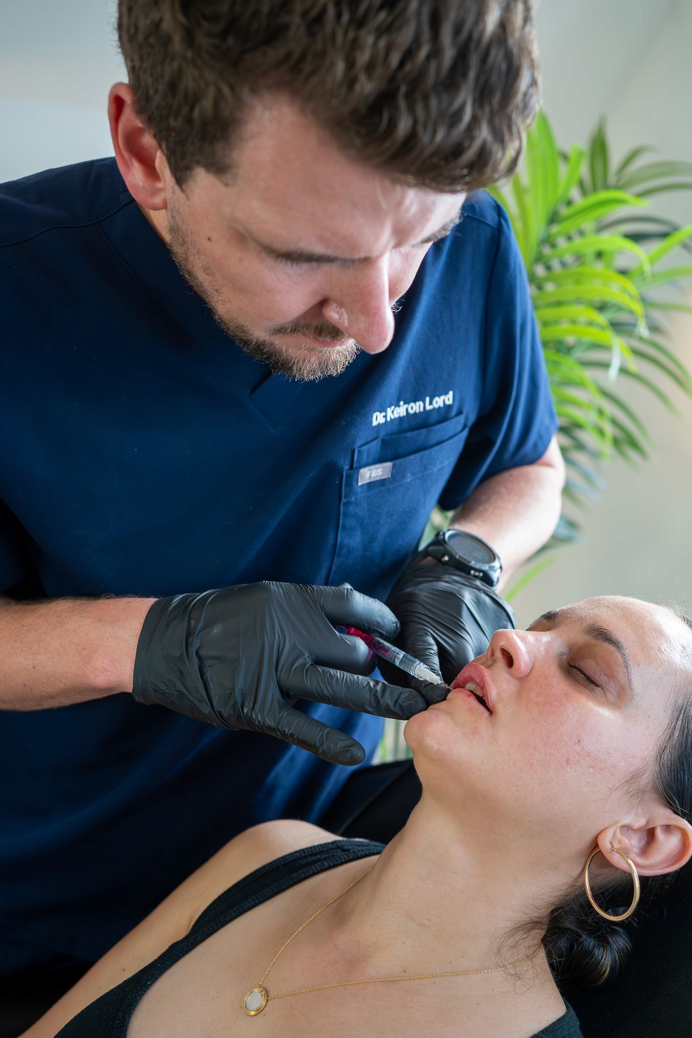 Dr. Keiron Lord performing aesthetic treatment